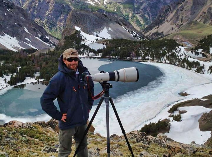Robbie George photographing a wild mountain landscape